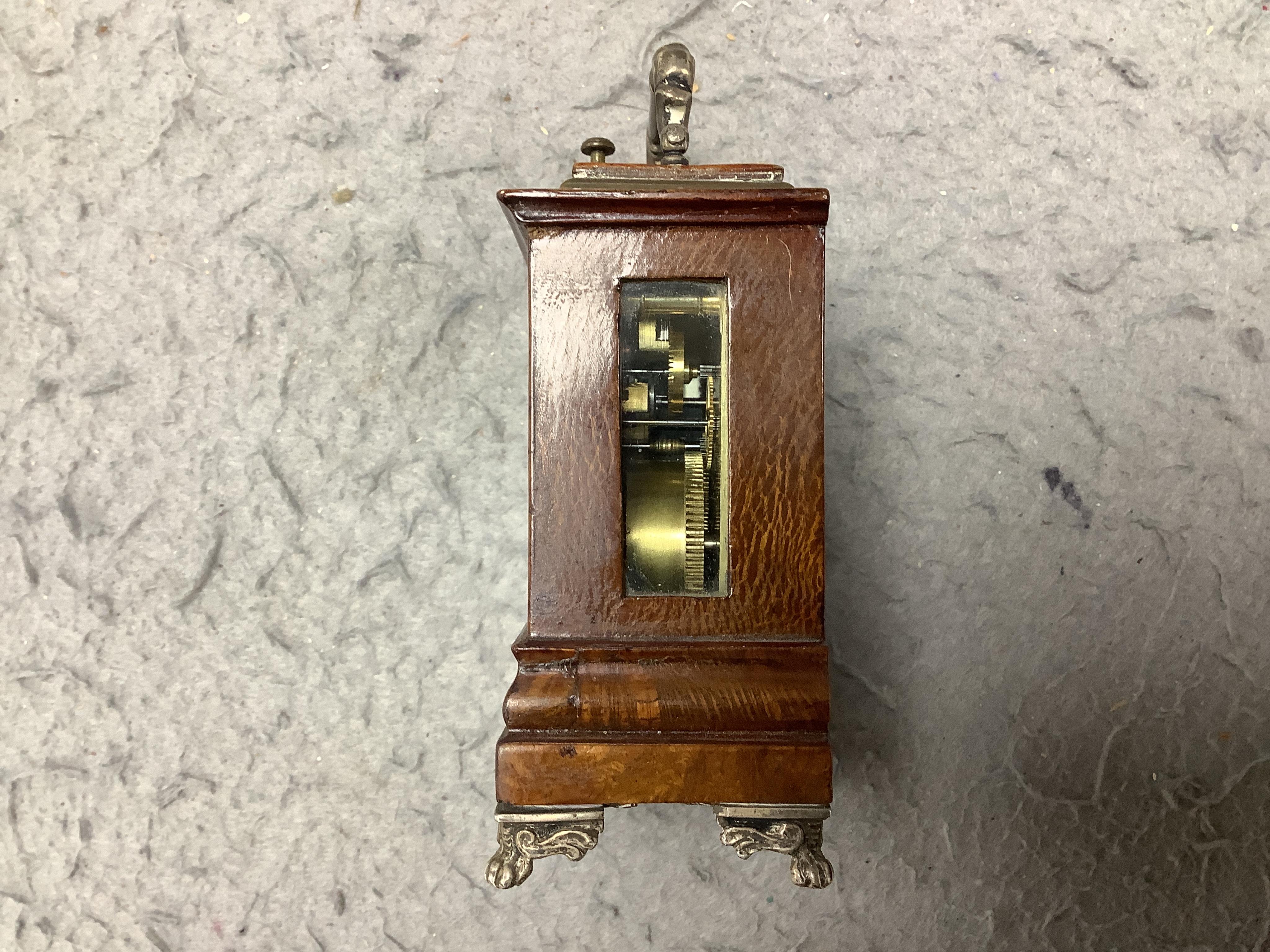 An early 20th century walnut miniature repeating carriage clock, with key, 8.5cm. Condition - fair, currently ticking